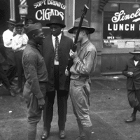 In the Bronzeville neighborhood of Chicago, a Black WWI veteran confronts a member of the white Illinois militia during the August 1919 “Red Summer” riots. During the six days of violence, 38 people died (23 Black and 15 white) and more than 500 were injured.